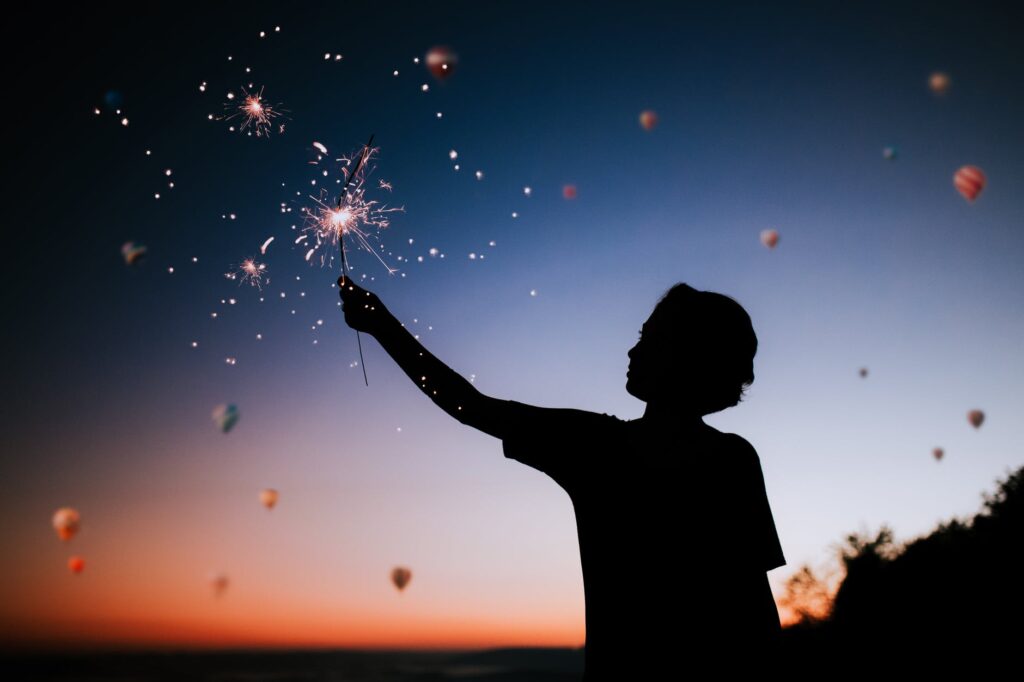 person holding sparkler silhouette